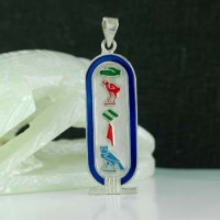 Silver cartouche with colored enamel borders and Colored symbols. 