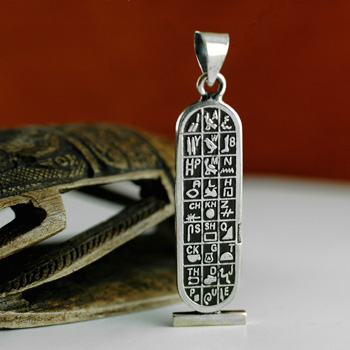 Silver Double Sided Egyptian Cartouche with hieroglyphic symbols table on  the back. With dark background.